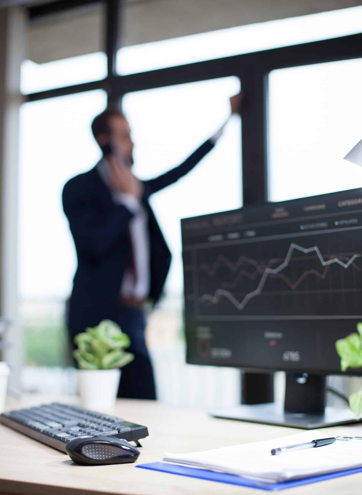 Data analysis displayed on marketing specialist computer in his office